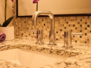 Quartz top, mosaic tile backsplash and chrome faucet tie our client’s powder room together. #njbathremodel #powderroomideas #designnj #bathtile #quartzcountertops #chromefaucets
