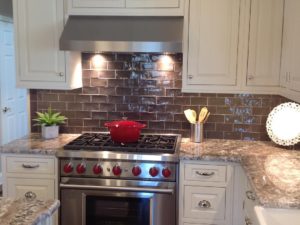 A nice pop of red in our client’s newly renovated kitchen. The dark backsplash tile looks classic too! #popofred #wolfstove #subzerowolf #kitchendesign #whitekitchen #subwaytile