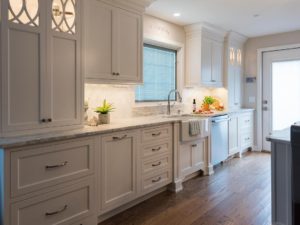 Love this shot of our client’s kitchen.  White custom cabinets with decorative inserts, farm sink, wood floors all add to the warm feeling of this space!  #designnj #njkitchen #customcabinets #woodfloors #njshorekitchenrenovations