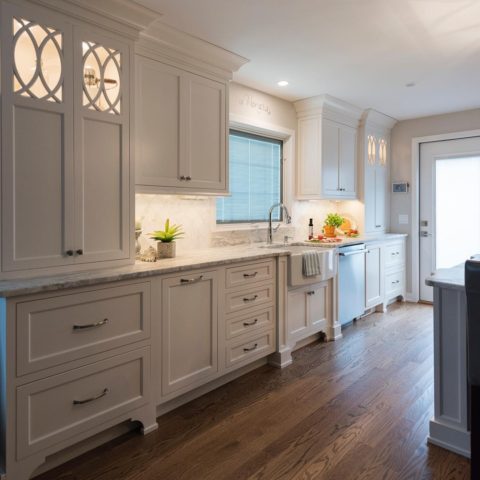 Love this shot of our client's kitchen.  White custom cabinets with decorative inserts, farm sink, wood floors all add to the warm feeling of this space!  #designnj #njkitchen #customcabinets #woodfloors #njshorekitchenrenovations