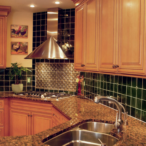 Our client's kitchen reno still looks great after all these years! #maplecabinets #tilebacksplash #granitecountertops #stainlesshood #warmkitchen #roosterkitchen #designnj #kitchendesign #newjerseykitchenandbath