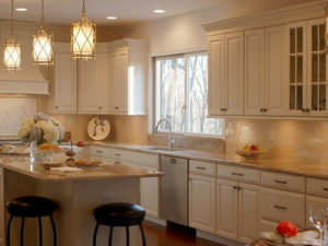 Swipe 👉🏼for a before and after view of our client’s newly renovated kitchen! #kitchenlighting #newjerseykitchenandbath #designnj #newjerseykitchenmakeover #maplecabinets #whitekitchen #granitecountertops #backsplashtile #woodflooring