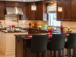 This two-toned kitchen reno combines warm dark cherry with English linen cabinets.  Titanium granite countertops, stainless appliances and a high spout faucet add a nice touch! #kitchendesign #designnj #kitchenshowroom #kitchenbaywindow #twotonedkitchen #stainlessappliances #subzerowolf