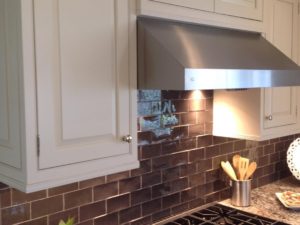 Dark subway tile is a nice contrast to our client’s white painted cabinetry and stainless appliances. #warmkitchen #insetcabinets #subwaytile #designnj #newjerseykitchenandbath #kitchendesign #njkitchens #whitekitchen #stainlessappliances