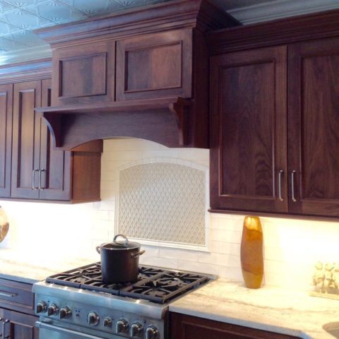 Custom @candlelight_cabinetry walnut oven hood in our client's new kitchen renovation! #walnutcabinets #designnj #newjerseykitchensdesign #customcabinetry #woodovenhood #insetcabinets