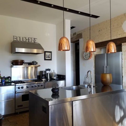 French designed gourmet kitchen in our France Chateau! #vacationviews #stainlesskitchen #stainlesscabinets #stainlesscounters #stainlesskitchenisland #designnj #njkitchenandbathdesign #copperpendantlights