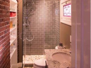 Texture Tuesday! We love this integration of tile, brick and stone in our client’s renovated bathroom! #graysubwaytile #brickdesign #stainglasswindows #customshower #designnj #newjerseykitchenandbath