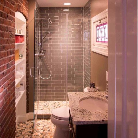 Texture Tuesday! We love this integration of tile, brick and stone in our client's renovated bathroom! #graysubwaytile #brickdesign #stainglasswindows #customshower #designnj #newjerseykitchenandbath