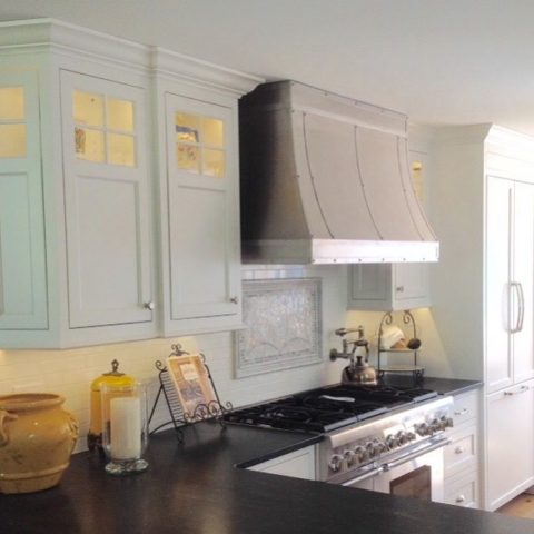 We love this custom stainless hood in our client's new kitchen! #customcabinetry #customhood #leatheredgranite #stainlessappliances #designnj #newjerseykitchenandbath #kitchendesign #whitekitchen