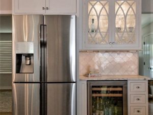 Beautiful new bar area in our client’s renovated kitchen! #glasscabinetdoors #stainlessappliances #whitekitchen #customcabinetry #designnj