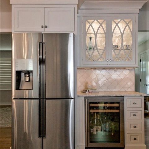 Beautiful new bar area in our client's renovated kitchen! #glasscabinetdoors #stainlessappliances #whitekitchen #customcabinetry #designnj