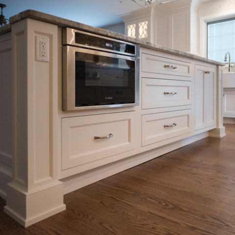 Client's kitchen island is super functional including electrical tucked into island column! #kitchendesign #njkitchens #designnj #kitchenislanddesign #stainlessmicrowave #whitekitchen #candlelightcabinetry