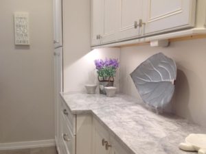 Storage @waypointlivingspaces cabinets in our client’s renovated laundry room. #laundryroom #laundryroommakeover #storagecabinet #quartzitecountertops #whitecabinets #designnj #njkitchenandbathdesigner