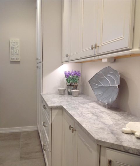 Storage @waypointlivingspaces cabinets in our client's renovated laundry room. #laundryroom #laundryroommakeover #storagecabinet #quartzitecountertops #whitecabinets #designnj #njkitchenandbathdesigner