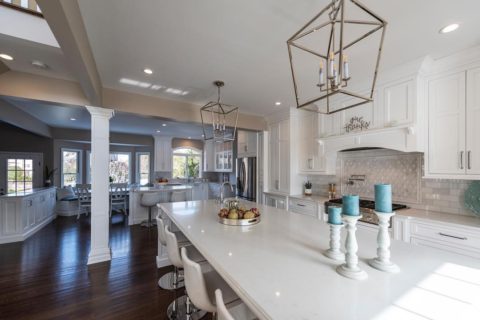 We love the island pendants in our client's new kitchen! #designnj #njdesigns #whitekitchen #newjerseykitchenandbathshowroom #kitchencounterstools #kitchenremodel