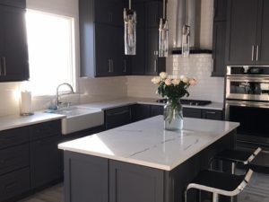 Just completed our client’s kitchen renovation project! Custom grey cabinets, Calcutta quartz, white subway tile and brushed satin nickel hardware complete the look! #greykitchen #greykitchencabinets #whitequartz #subwaytile #farmsink #kitchenpendants #barstools #kitchendesign #njkitchens