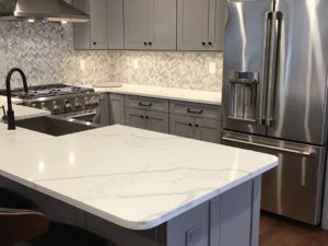 Quartz countertops, an excellent alternative to marble for a more durable, timeless look!#quartzcountertops #marblelook #njkitchens #newjerseykitchenremodel #designnj #newjerseykitchenandbathshowroom #stainlessappliances #graycabinets #woodfloors