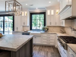 This kitchen is so ready for the Holidays! #designnj #readyforchristmas #honedgranite #twotonedkitchen #woodliketile #islandlighting #blacktrim #woodhood #tilebacksplash #kitchenisland #kitchenrenovation2019 #newjerseykitchenandbath
